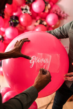 Crop hand of unrecognizable man creating decoration from air balloons 