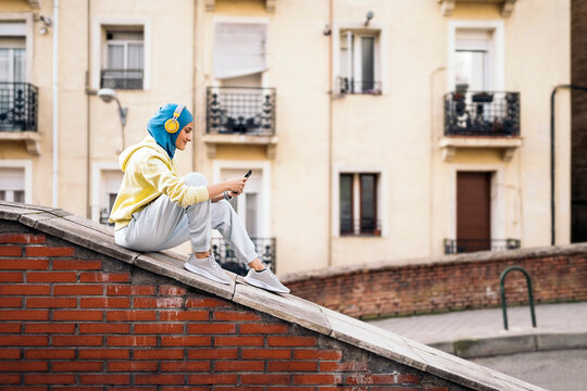 Muslim Runner Using Phone - Powered by Adobe