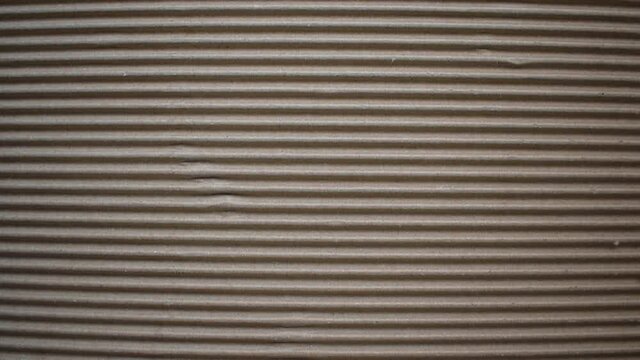 Dark brown color corrugated cardboard box textured background with horizontal ridges