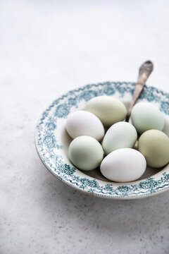 Mixed colored eggs on vintage plate