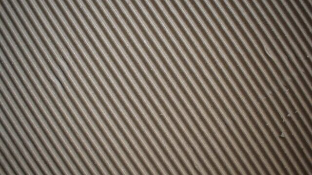 Dark brown color corrugated cardboard box textured background with diagonal ridges
