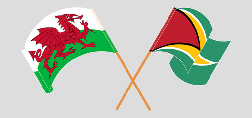 Crossed and waving flags of Wales and Guyana