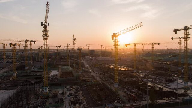 Aerial Flight Over a New Constructions Development Site with High Tower Cranes Building Real Estate. Heavy Machinery and Construction Workers are Employed. Xiongan new area of Beijing china.