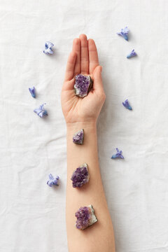 Female hand with magic amethyst crystals