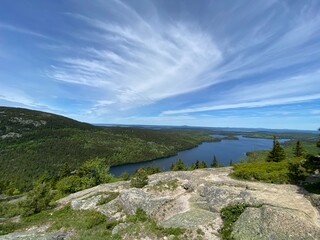 Rocky Ledge Overlooking Water In Maine, Blue Skies with Wispy Clouds