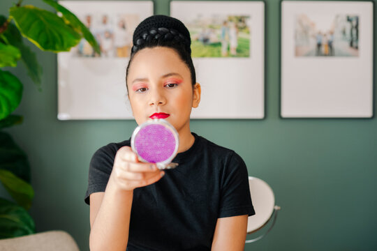 Pre-teen girl looking at a beauty mirror after got her makeup