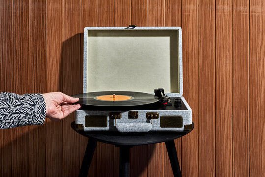 man about to play a disc in a turntable