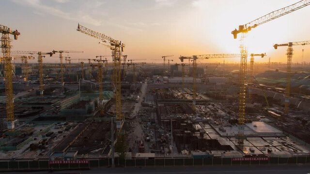 Aerial Flight Over a New Constructions Development Site with High Tower Cranes Building Real Estate. Heavy Machinery and Construction Workers are Employed. Xiongan new area of Beijing china.