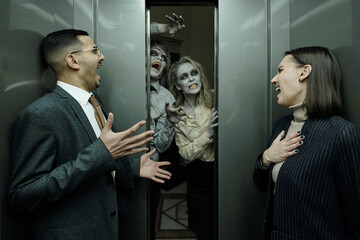 Terrified office managers screaming in elevator while zombies frightening them
