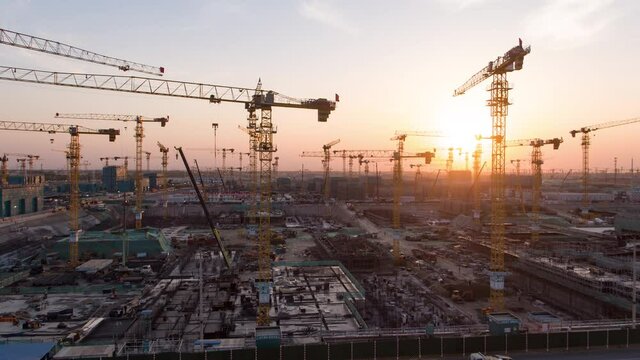 Aerial Flight Over a New Constructions Development Site with High Tower Cranes Building Real Estate. Heavy Machinery and Construction Workers are Employed. Xiongan new area of Beijing china.