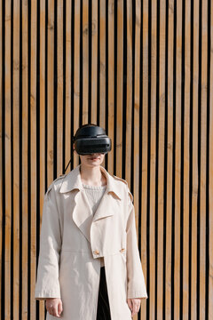 Stylish young woman in VR headset on street