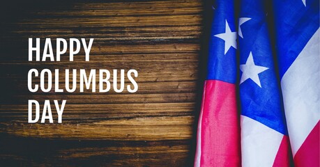 Happy columbus day text over american flag against wooden background