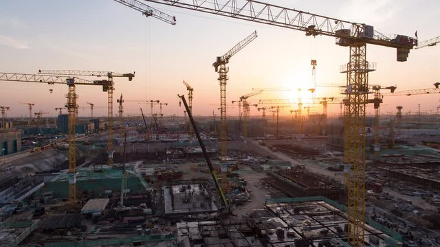 Aerial Flight Over a New Constructions Development Site with High Tower Cranes Building Real Estate. Heavy Machinery and Construction Workers are Employed. Xiongan new area of Beijing china.