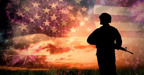 Composition of silhouette of soldier against sunset sky and billowing american flag