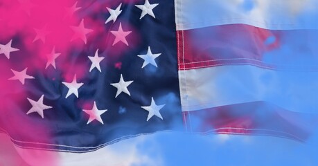 Composition of billowing american flag with colourful pink and blue flare smoke