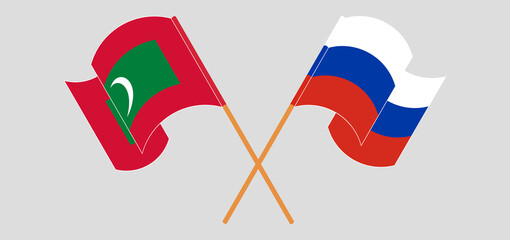 Crossed and waving flags of Maldives and Russia