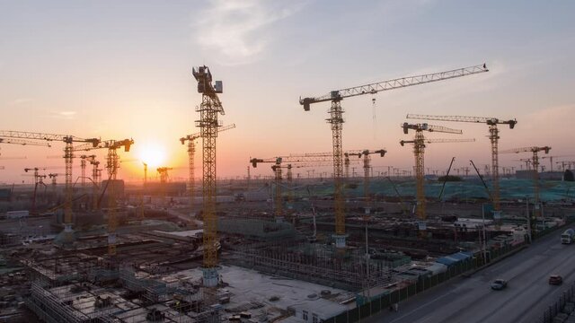Aerial Flight Over a New Constructions Development Site with High Tower Cranes Building Real Estate. Heavy Machinery and Construction Workers are Employed. Xiongan new area of Beijing china.