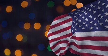 Composition of billowing american flag over orange, blue and green bokeh lights on dark background