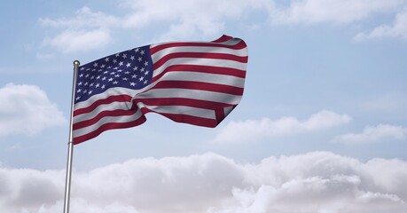 Fototapeta premium Composition of billowing american flag on flagpole over cloudy blue sky