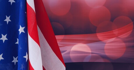 Composition of billowing american flag over defocussed red bokeh lights on dark background