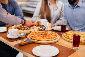 Obraz na płótnie Canvas Unique hot pizza on fire close-up during a friendly dinner.
