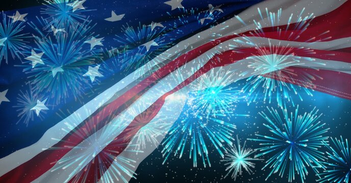 Composition of american flag billowing over blue fireworks in night sky