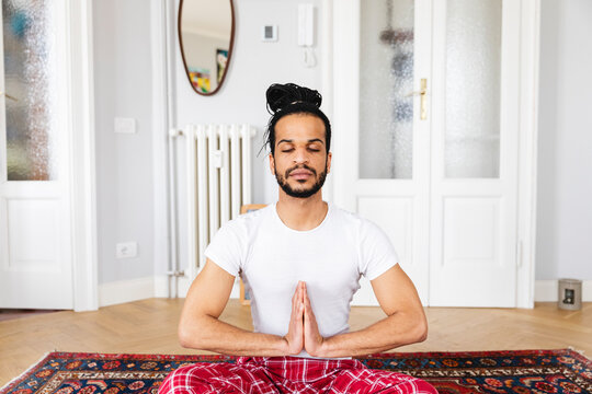 Man meditating at home