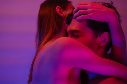Shirtless young man hugging boyfriend