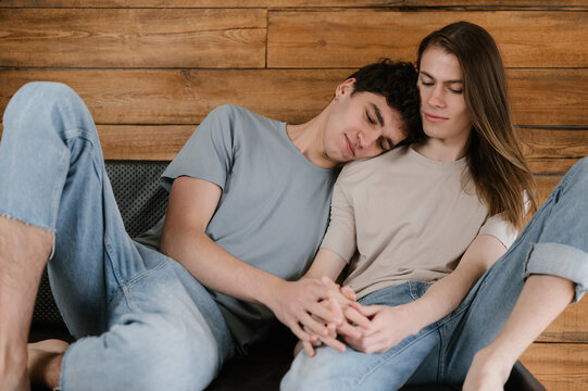 Young gay couple resting on couch