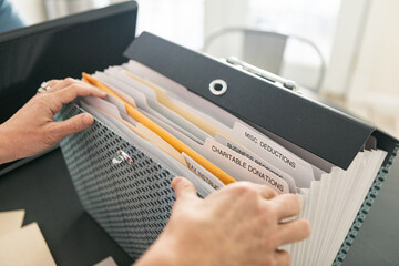 Taxes: Woman Finds Charitable Deductions Section in Folder