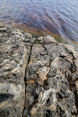 Rocky coast of a island with traces of erosion. Lakes of glacial origin.