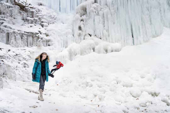 Family Exploring Tiffany Falls Hamilton Frozen Waterfall in Wint