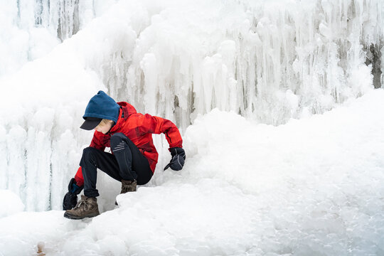Boy with Icy Tiffany Falls Hamilton Frozen Waterfall in Winter