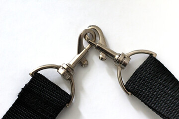 Two shoulder strap key rings fastened to each other, could be concept for 