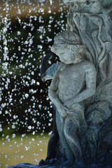 Fototapeta na wymiar New Ulm, MN USA - 06-14-2021 - Close up of Cherub in the Water Fountain in German Park