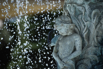 Fototapeta na wymiar New Ulm, MN USA - 06-14-2021 - Close up of Cherub in the Water Fountain in German Park