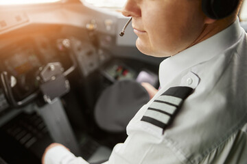 Male pilot in cockpit of passenger airplane jet © Ivan