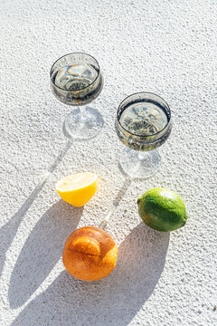 Still life of citrus and glassware on concrete background