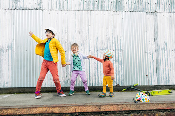 kids with helmets holding hands while dancing