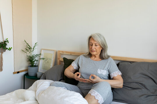 mature woman  meditating during morning time at home