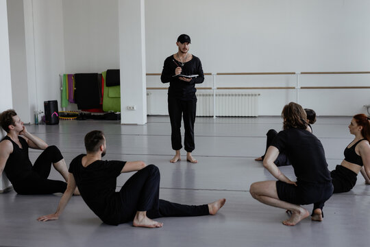 Team of performers listening to their trainer 