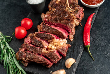 grilled cowboy beef steak on stone background