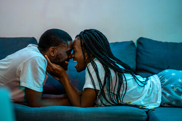 Happy Couple In Love Lying On The Couch.  