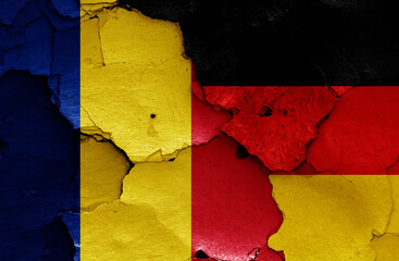 flags of Romania and Germany painted on cracked wall