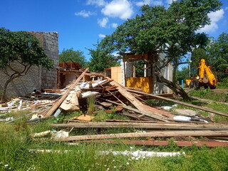 wreckage of an old destroyed wooden house, demolition of a private sector
