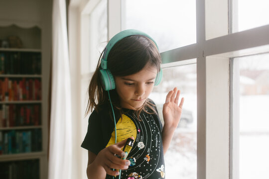 Young girl with teal headphones 