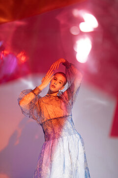 stylish bald model under red light