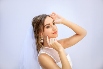 Brunette girl in a wedding dress. Bride in a white dress. Makeup.