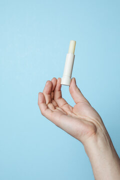 Hand with a lip balm