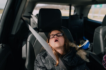 Girl sleeping with mouth open in the car. 